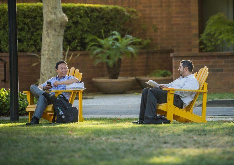 students sitting in lawn chairs
